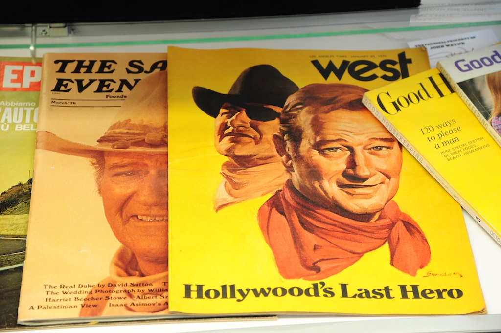 John Wayne's face appears on the covers of many magazines.