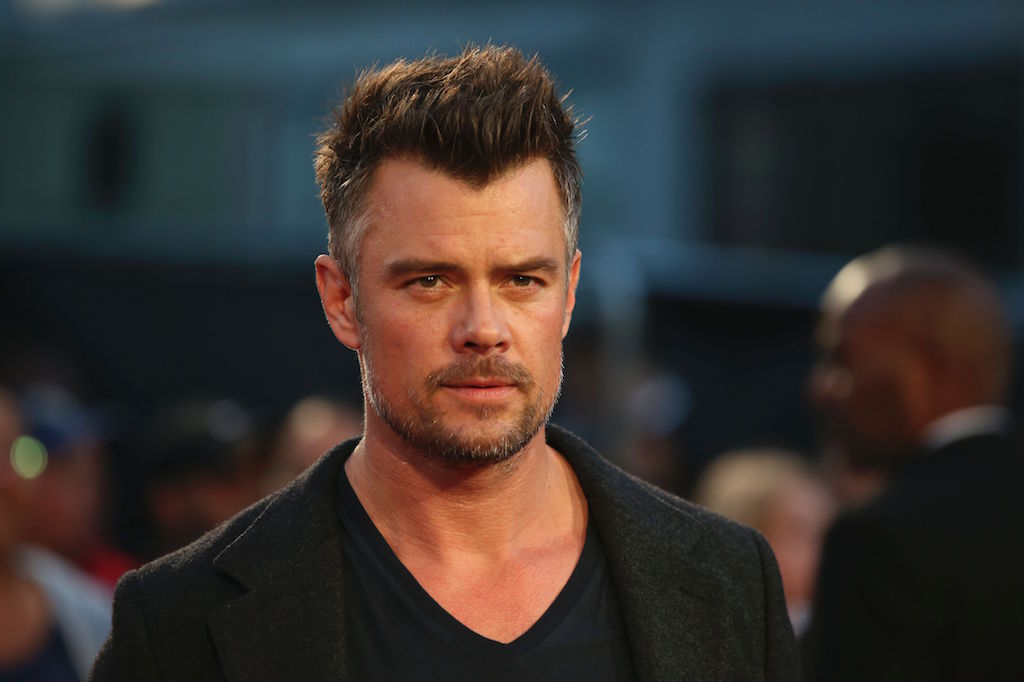 Actor Josh Duhamel stands on the red carpet at an event.