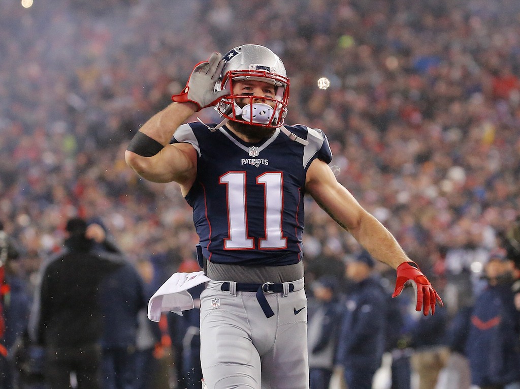 Julian Edelman pumps up the crowd as he holds his hand to his ear.