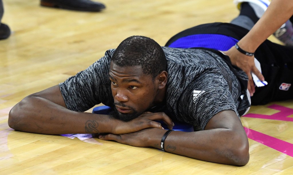 Kevin Durant stretches his legs during warmups.