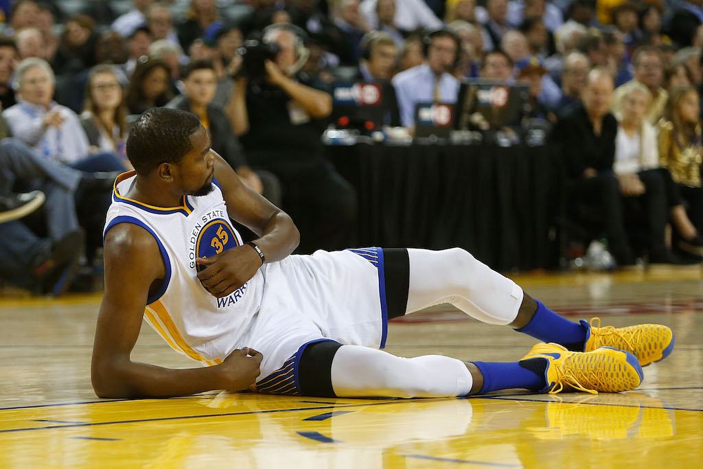 Kevin Durant lands on the ground after falling.