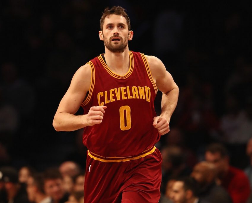 Kevin Love looks at the scoreboard and runs down the court.