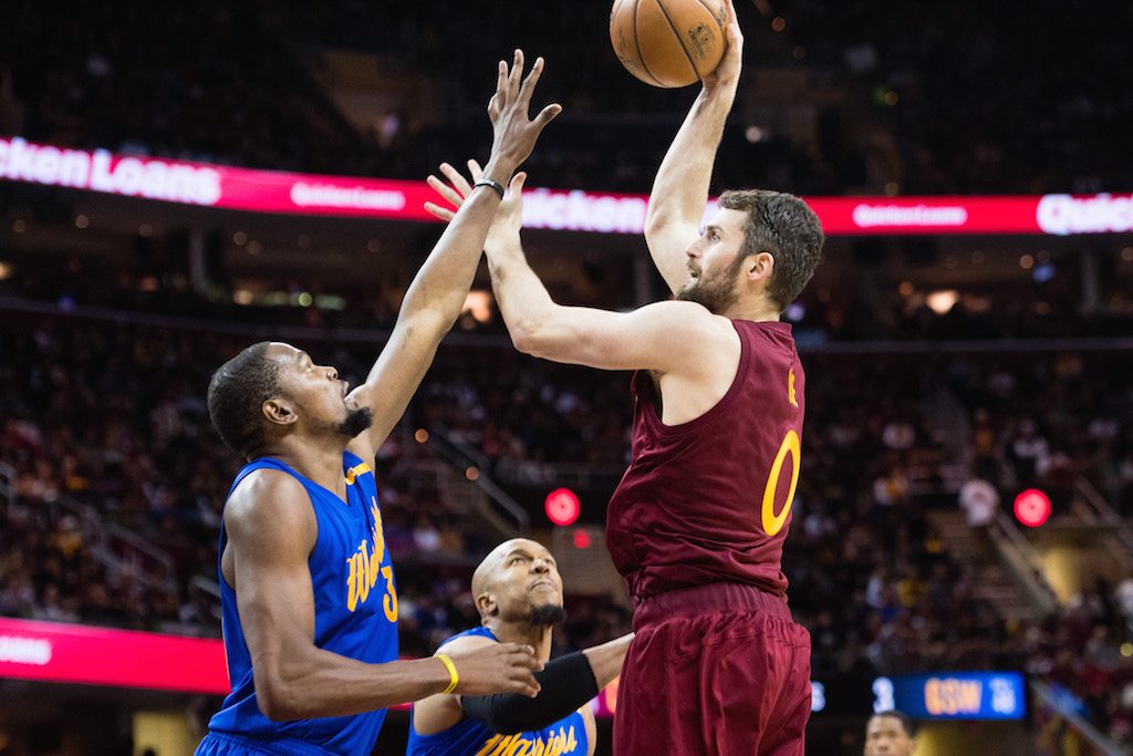 Kevin Love jumps above Kevin Durant to score.