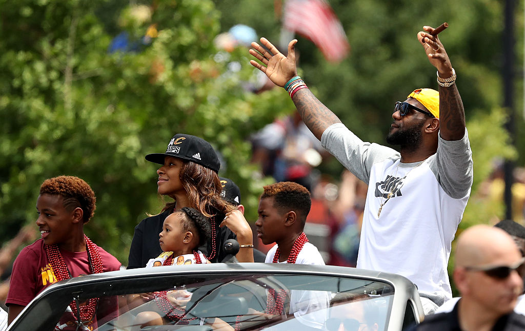 LeBron James of the Cleveland Cavaliers and his family look on during the Cleveland Cavaliers 2016 NBA Championship victory parade | Mike Lawrie/Getty Images