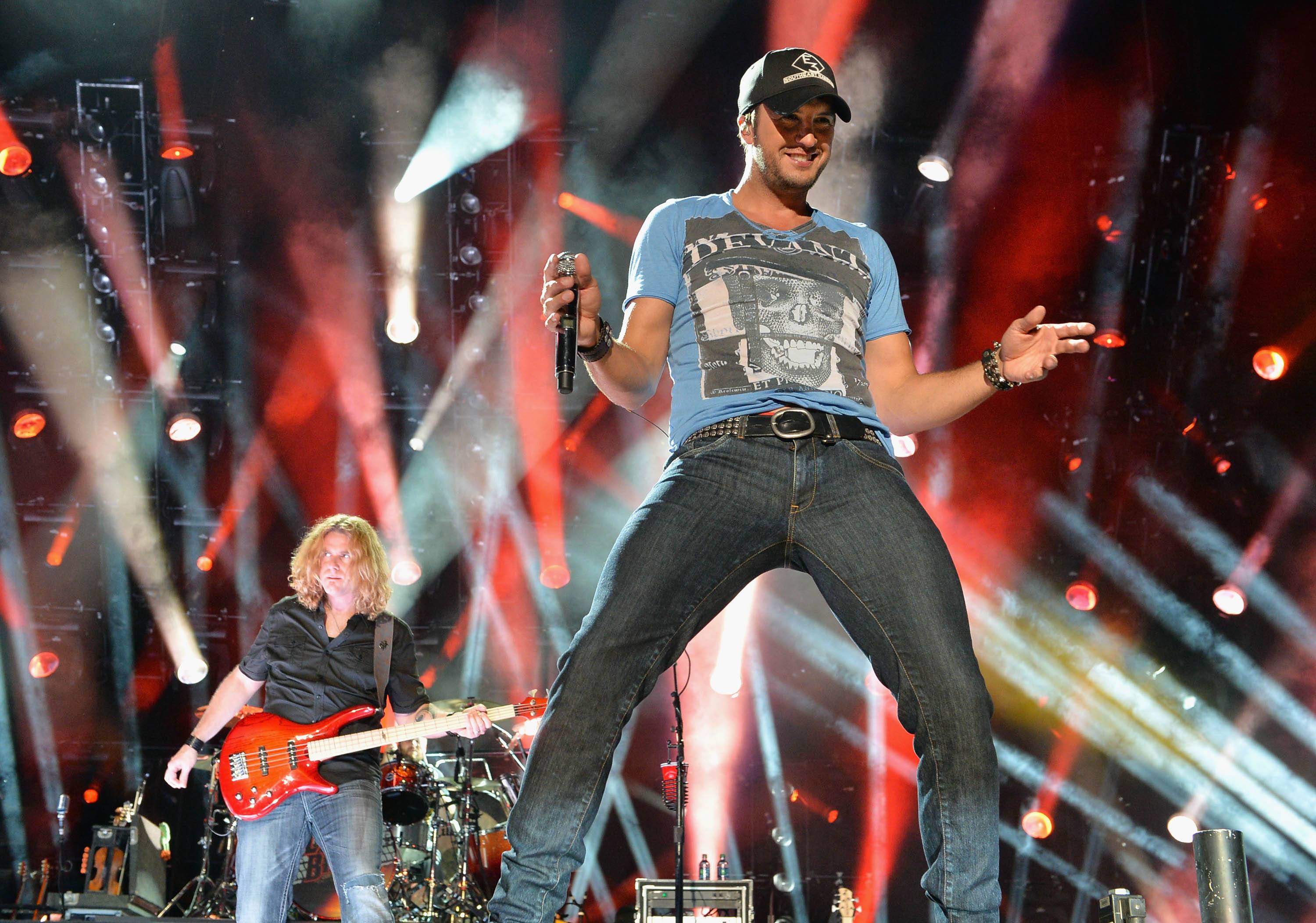 Luke Bryan smiles onstage during a performance.