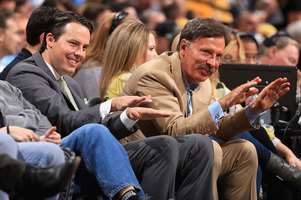 Stan Kroenke bows down from his seat on the sideline after his team scored.