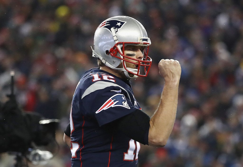 Tom Brady pumps his fist after throwing a touchdown pass.