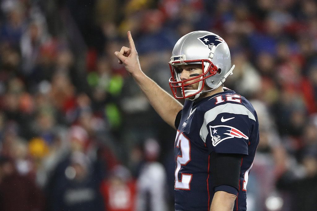 Tom Brady holds up his finger before a play.