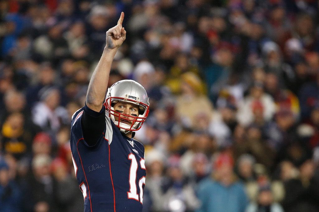 Tom Brady raises his finger in the air, symbolizing that he's No. 1.