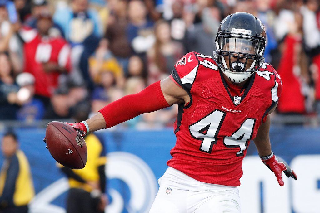 Vic Beasley grips the ball and runs into the end zone.