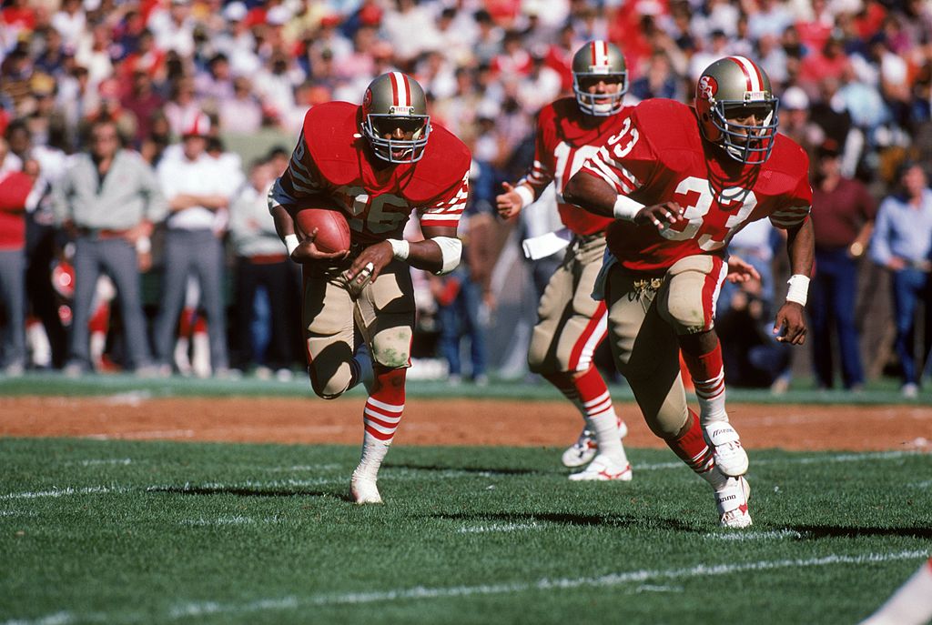 Running back Wendell Tyler of the San Francisco 49ers runs behind the protection of teammate running back Roger Craig.