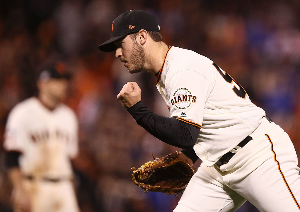 Ty Blach of the San Francisco Giants celebrates after a double play ends the thirteenth inning against the Chicago Cubs