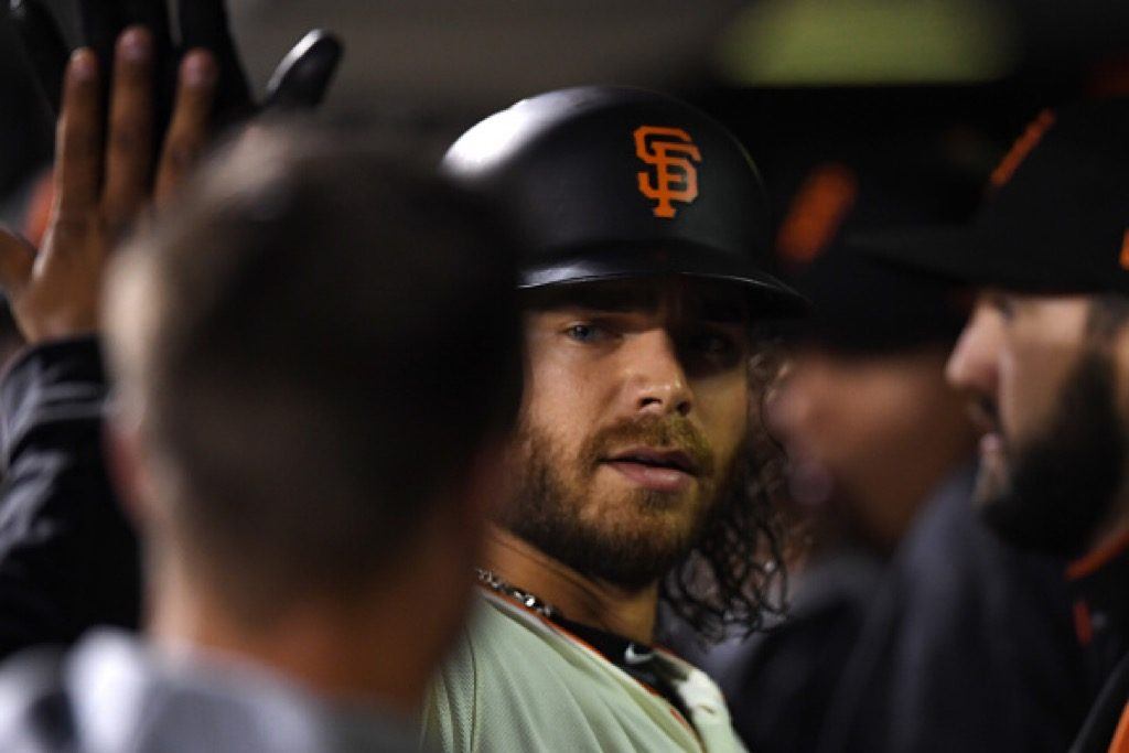 Brandon Crawford of the San Francisco Giants celebrates in the dugout after scoring.