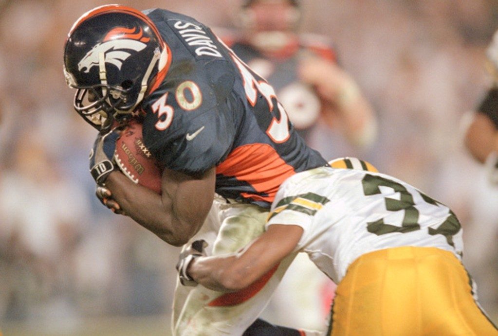 Terrell Davis of the Denver Broncos looks to break the tackle of Tyrone Williams of the Green Bay Packers during Super Bowl XXXII.