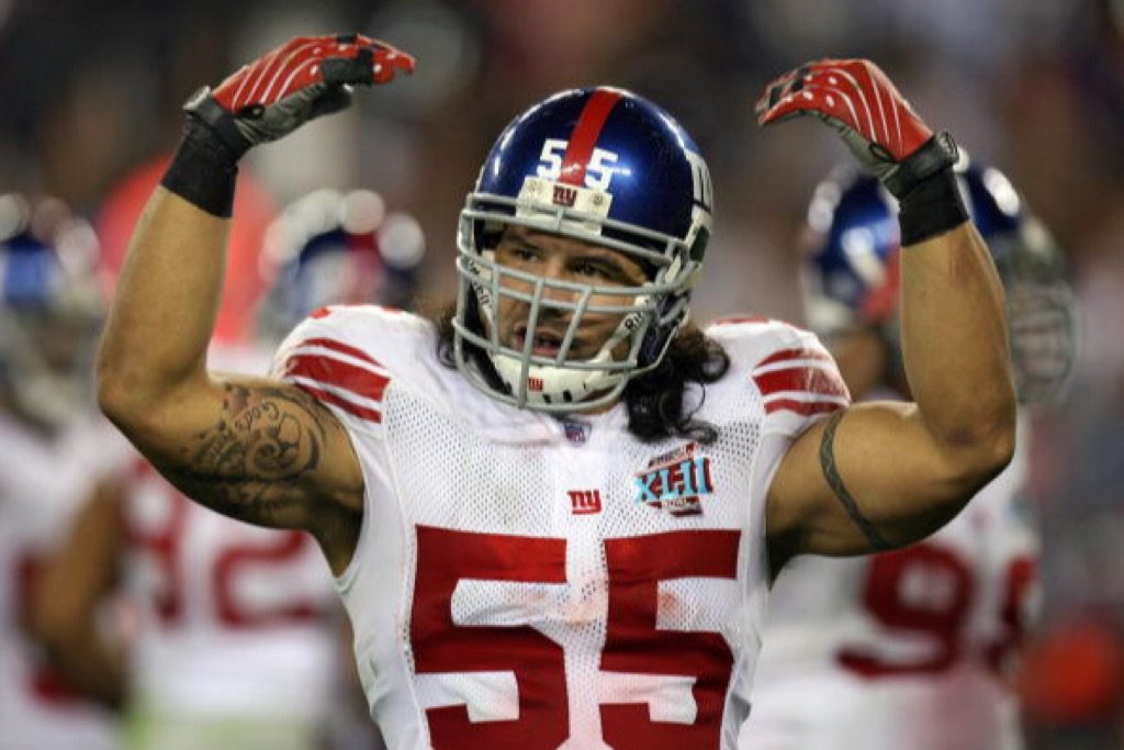 Kawika Mitchell of the New York Giants raises his arms during Super Bowl XLII.