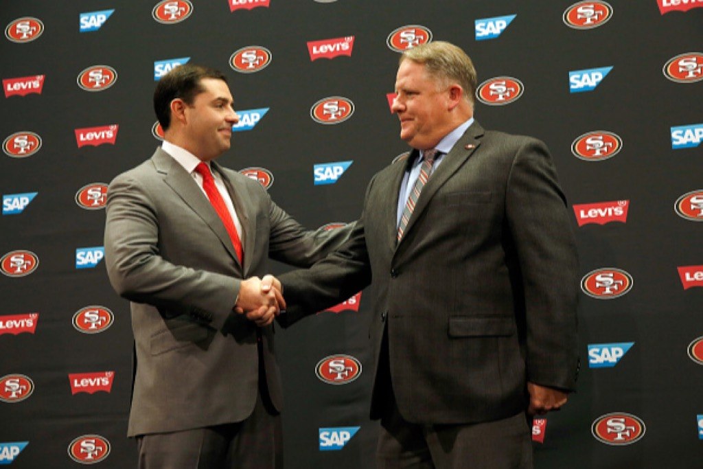 San Francisco 49ers CEO Jed York shakes hands with Chip Kelly.