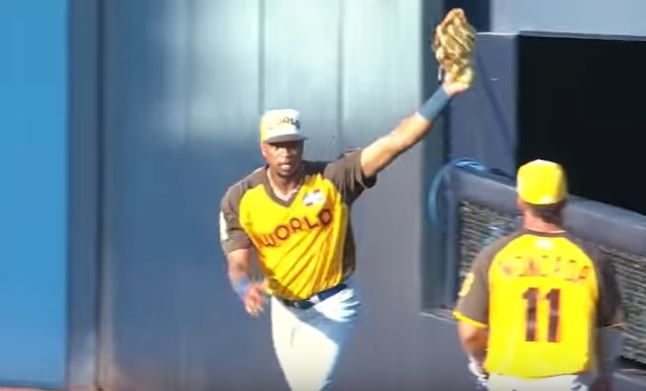 Eloy Jimenez holds his glove in the air after making a catch