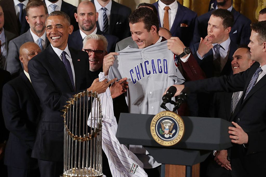U.S. President Barack Obama (L) receives a uniform from World Series champion Chicago Cubs player Anthony Rizzo during a celebration of the team's win.