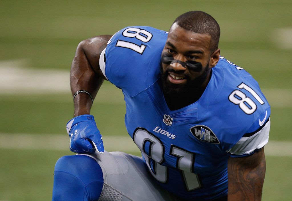 Calvin Johnson kneels on the field during warmups.