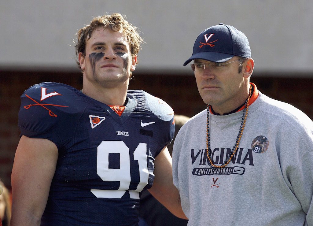 Virginia's Chris Long stands next to his coach.