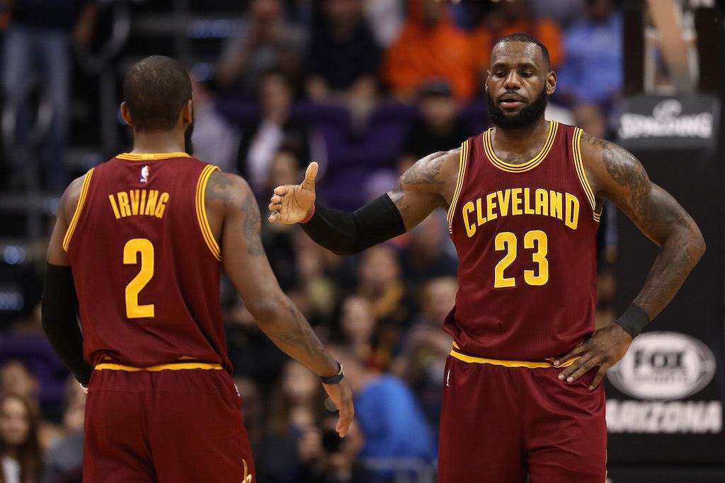 Kyrie Irving and LeBron James slap hands.