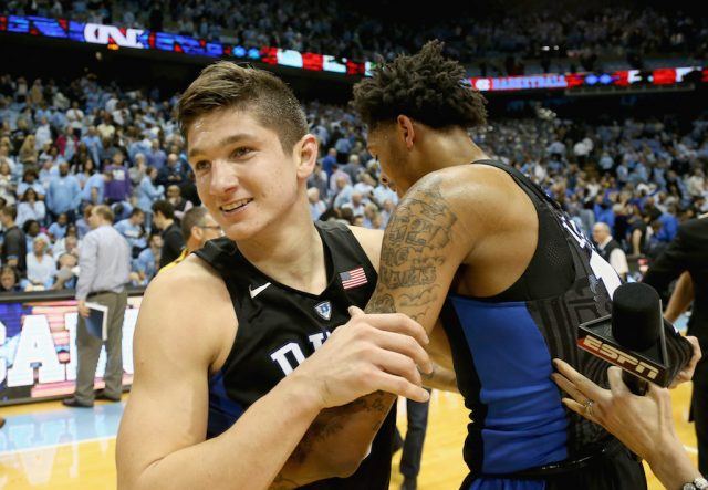 Grayson Allen hugs a teammate after winning a game.