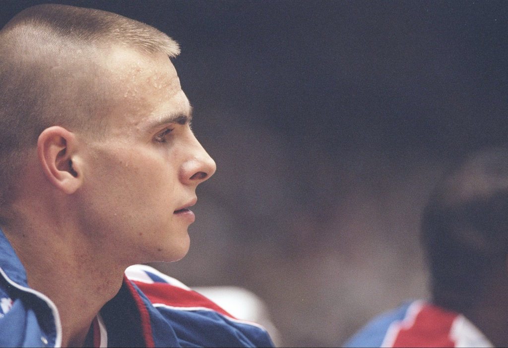 Eric Montross sits on the bench and watches the action.