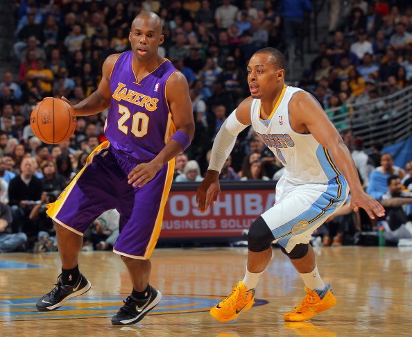 Jodie Meeks of the Los Angeles Lakers controls the ball against Randy Foye of the Denver Nuggets.
