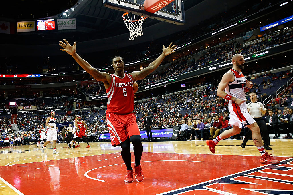 Terrence Jones of the Houston Rockets celebrates after dunking the ball in front of Marcin Gortat of the Washington Wizards.