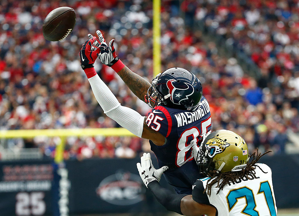 Nate Washington of the Houston Texans reaches for a pass while being covered by Davon House of the Jacksonville Jaguars | Scott Halleran/Getty Images