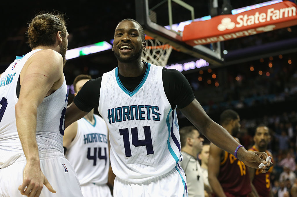 Michael Kidd-Gilchrist holds back teammate Spencer Hawes of the Charlotte Hornets after an altercation with J.R. Smith of the Cleveland Cavaliers.