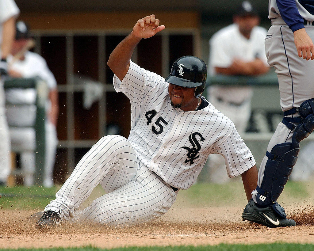 Carlos Lee of the Chicago White Sox slides across home plate on a double by teammate Juan Uribe.