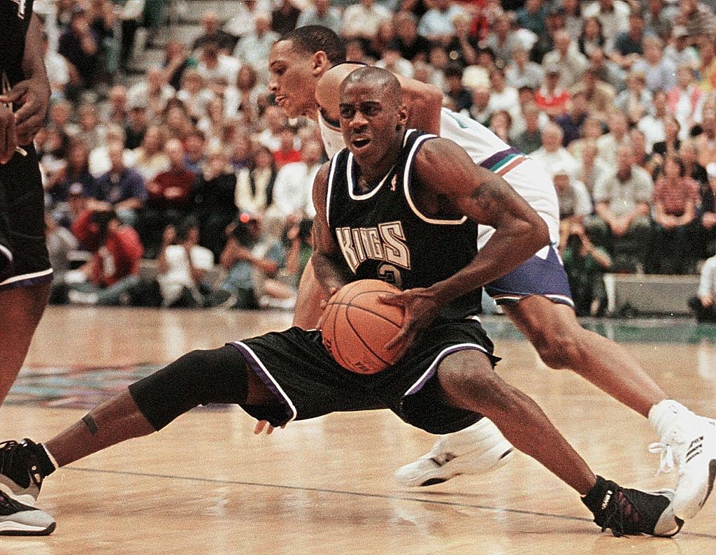 Vernon Maxwell of the Sacramento Kings loses balance as he tries to go around Shandon Anderson of the Utah Jazz.