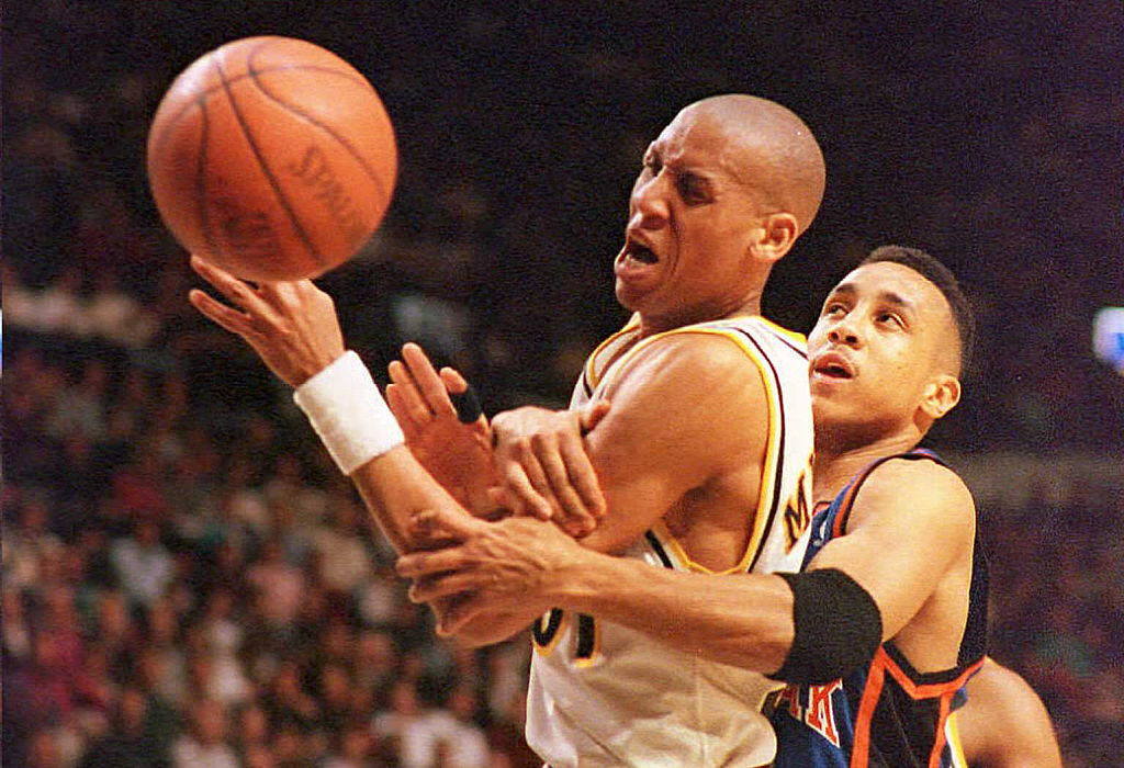 New York Knicks guard John Starks commits a foul on Indiana Pacers guard Reggie Miller. 