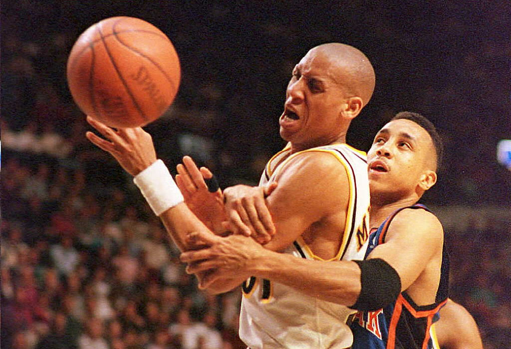 New York Knicks guard John Starks commits a foul on Indiana Pacers guard Reggie Miller.