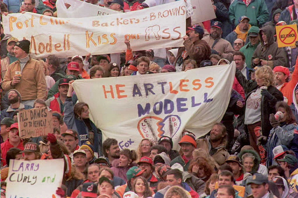 Cleveland Browns fans in the "dawg pound" section of the Cleveland stadium hold up signs during a Green Bay Packers-Browns game.