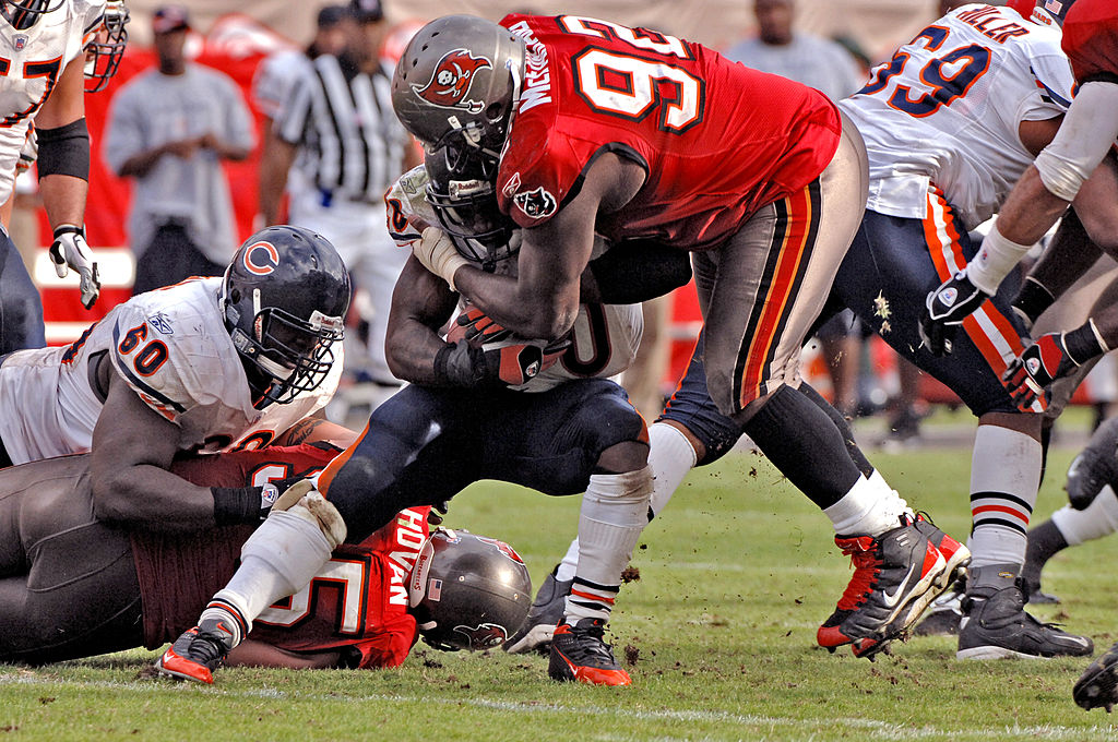 Anthony McFarland tackles Chicago Bears running back Thomas Jones.