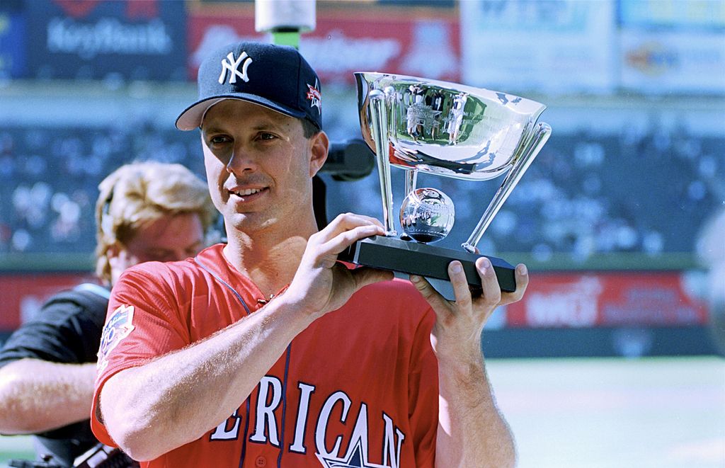 Tino Martinez of the New York Yankees holds up a trophy after the 1997 MLB All-Star Game.
