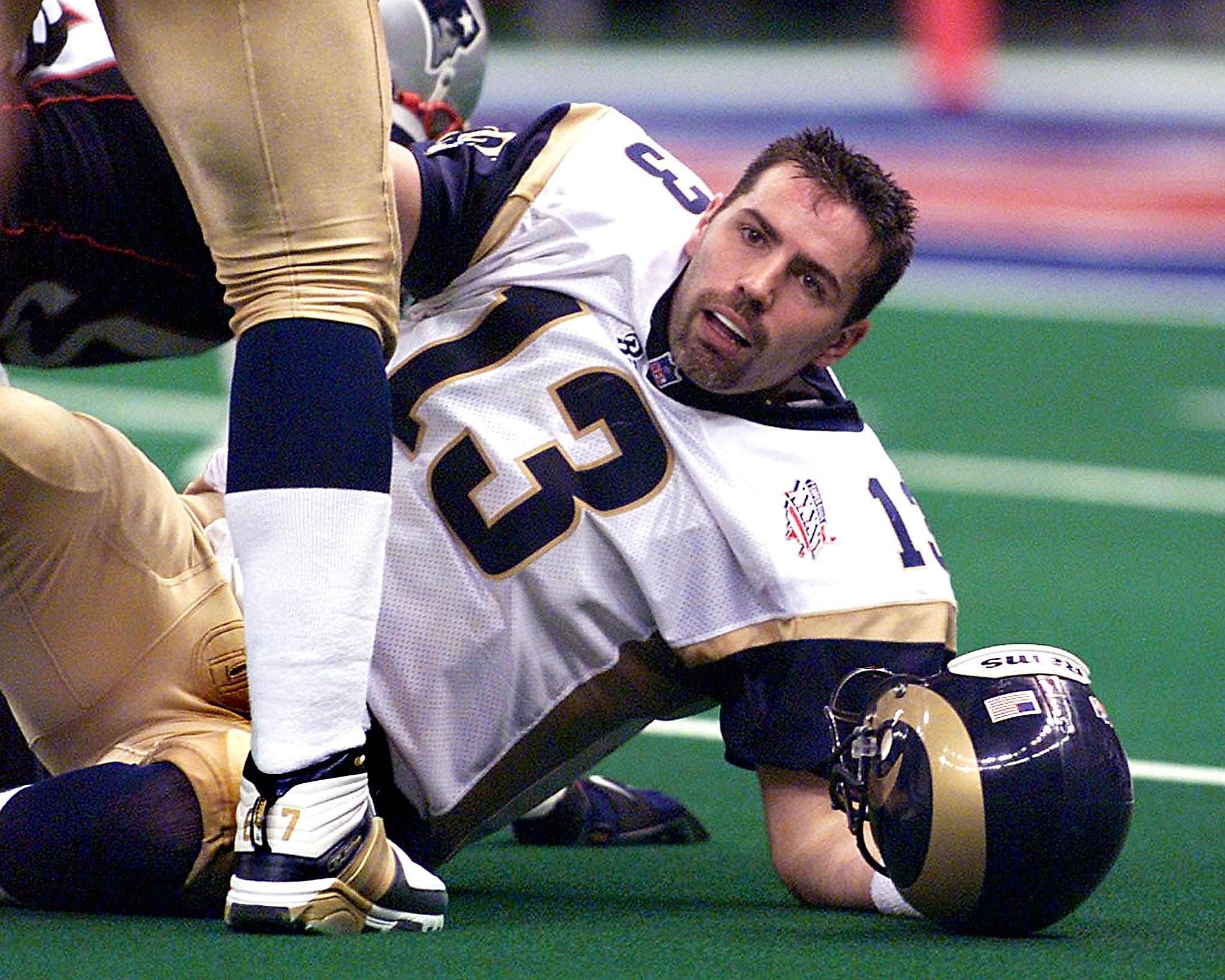 St. Louis Rams' quarterback Kurt Warner lies on the turf after being sacked by the New England Patriots during the second half 03 February, 2002 of Super Bowl XXXVI in New Orleans, Louisiana. The Patriots won 20-17. 