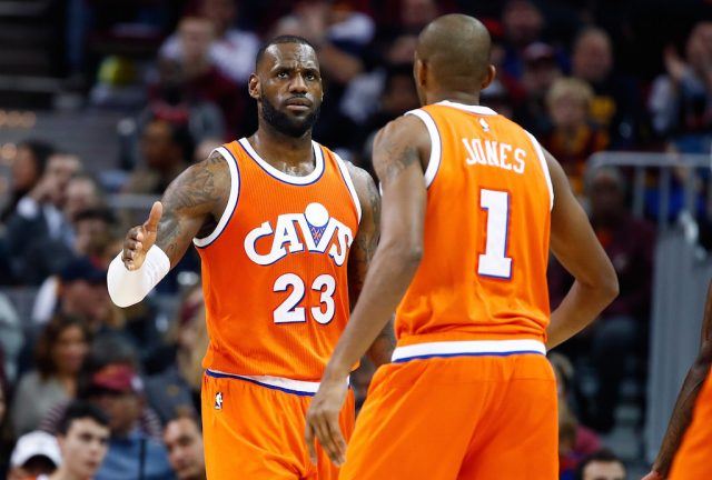 LeBron James low fives his teammate.