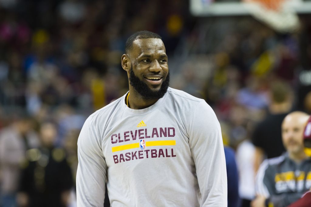 Lebron James smiles while he stands on the court. 