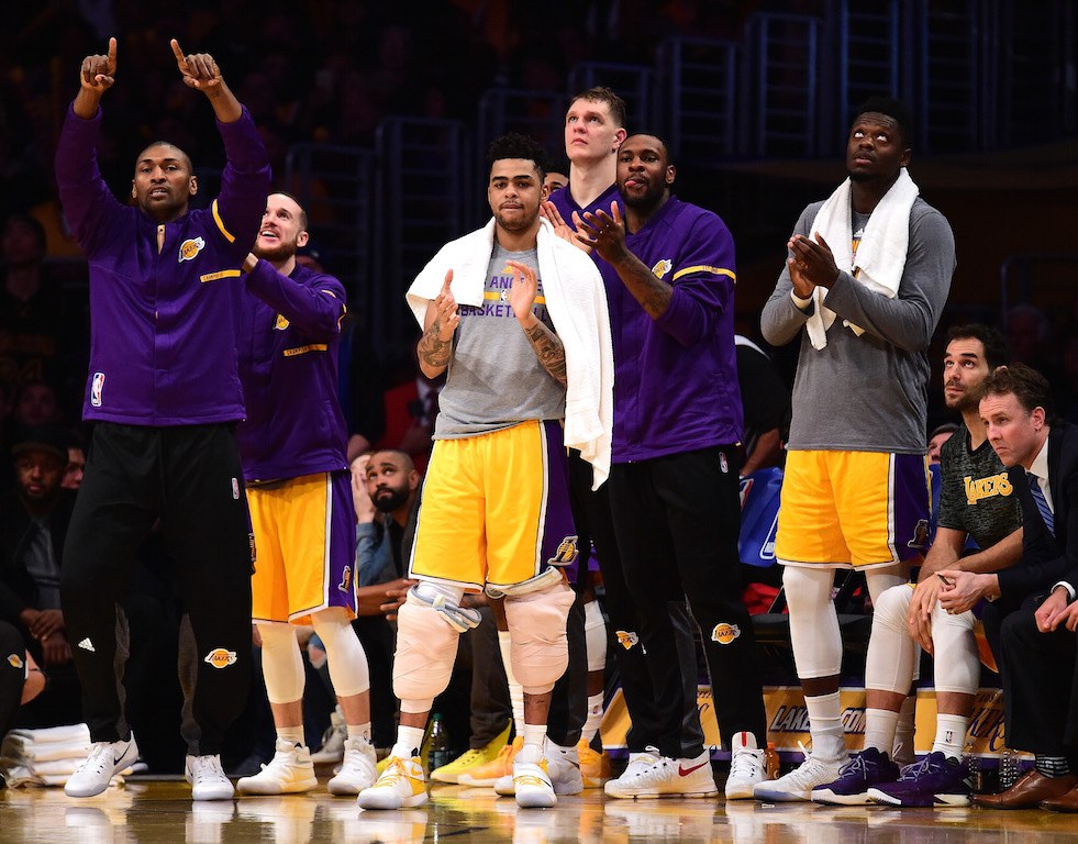 The Los Angeles Lakers applaud from the bench.