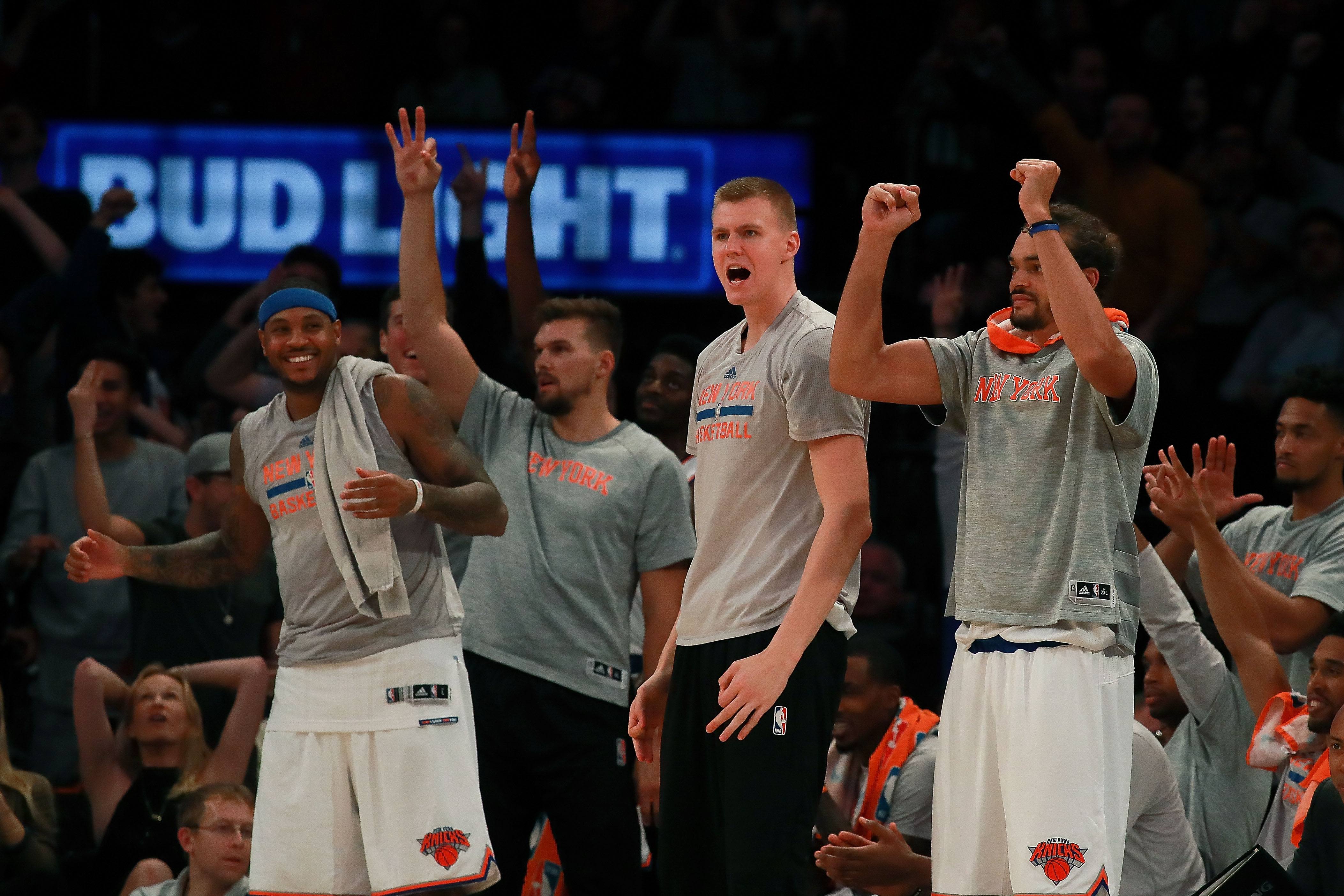 The Knicks cheer from the sidelines.