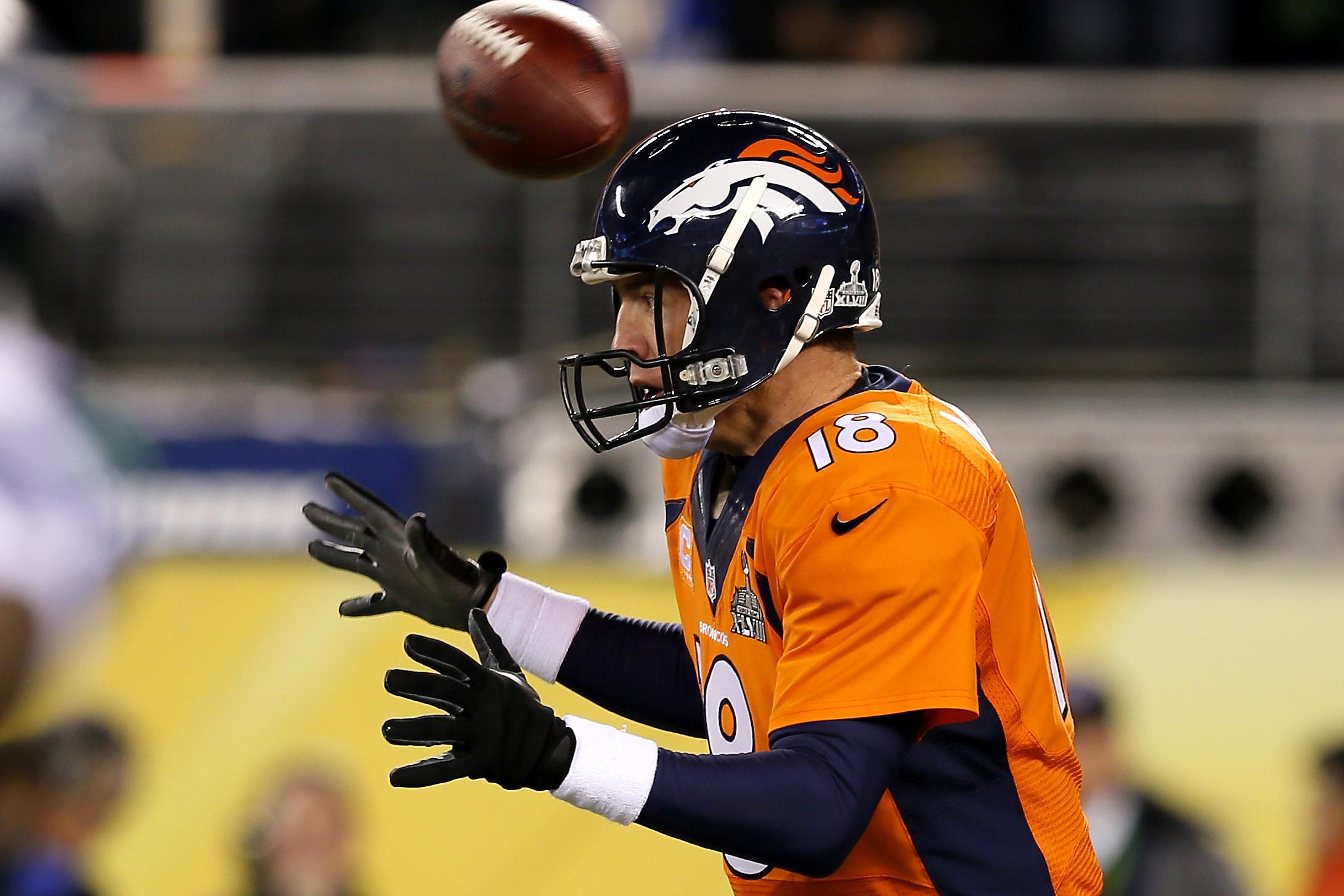 On the first play of Super Bowl XLVIII, the ball goes straight over Peyton Manning's head 