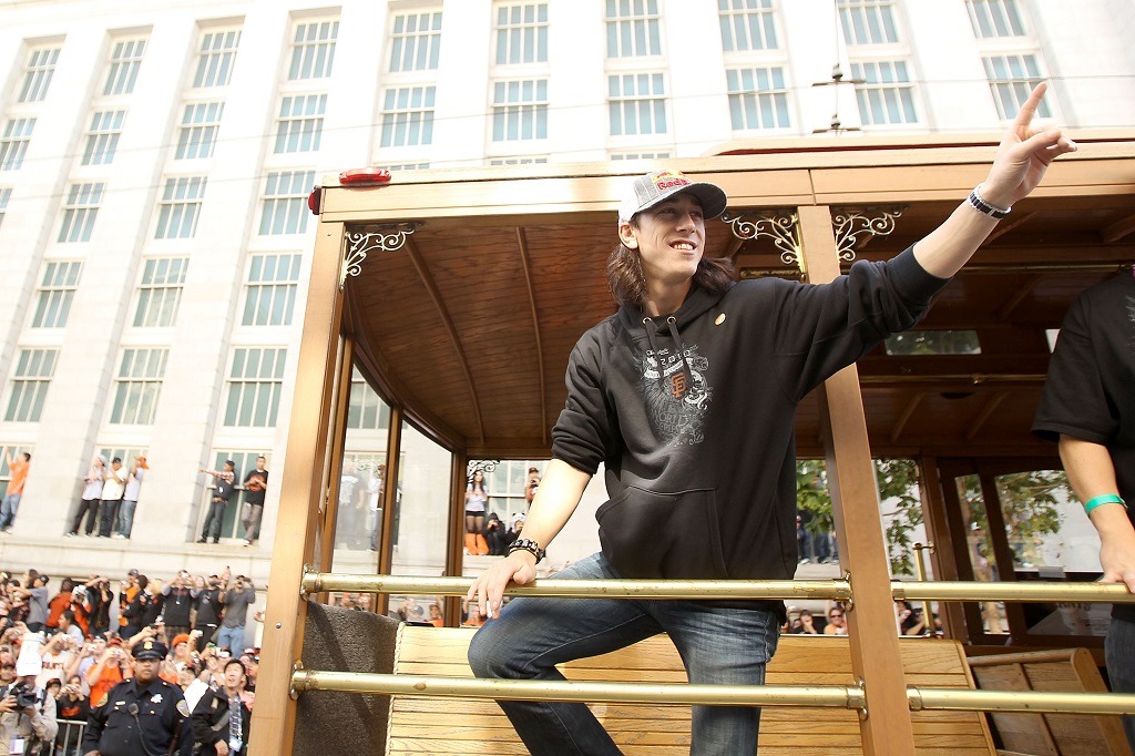 Tim Lincecum waves at the crowd during the victory parade.