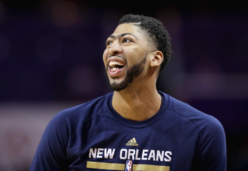Anthony Davis smiles while watching the Pelicans play.
