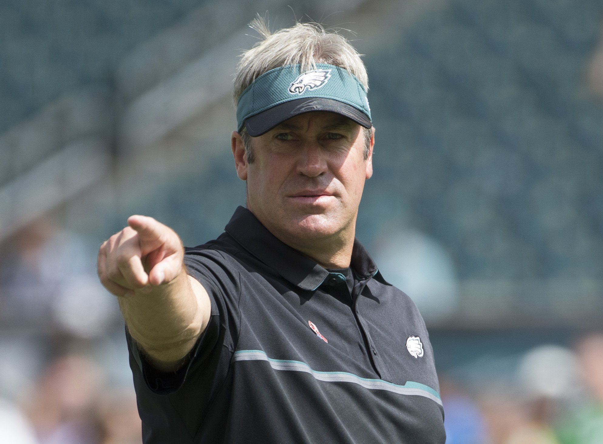 Doug Pederson points out at the field.