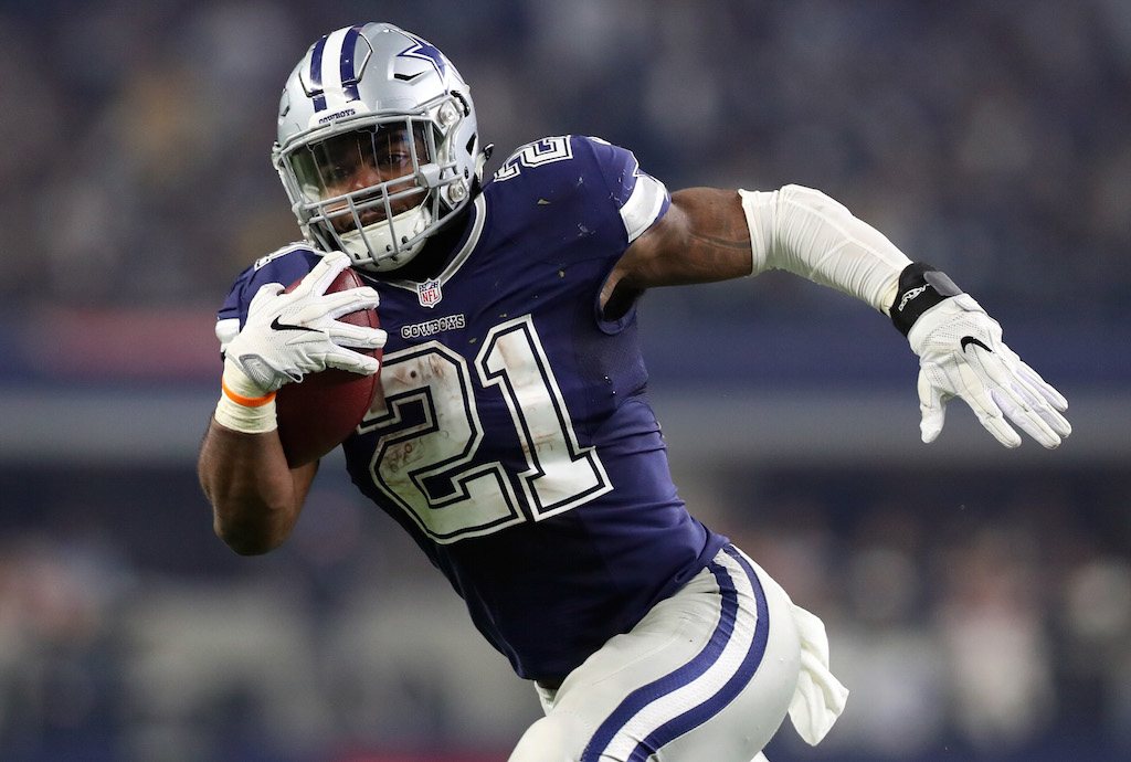 Ezekiel Elliott rushes with the ball. Ezekiel Elliott #21 of the Dallas Cowboys rushes the ball.