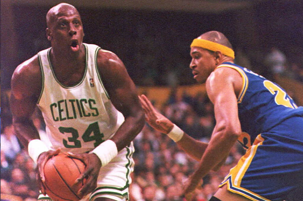 Xavier McDaniel of the Boston Celtics drives to the basket past Chris Gatling of the Golden State Warriors.