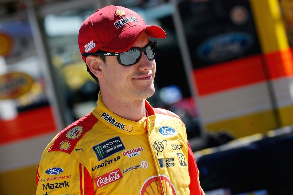 Joey Logano walks through the garage area.